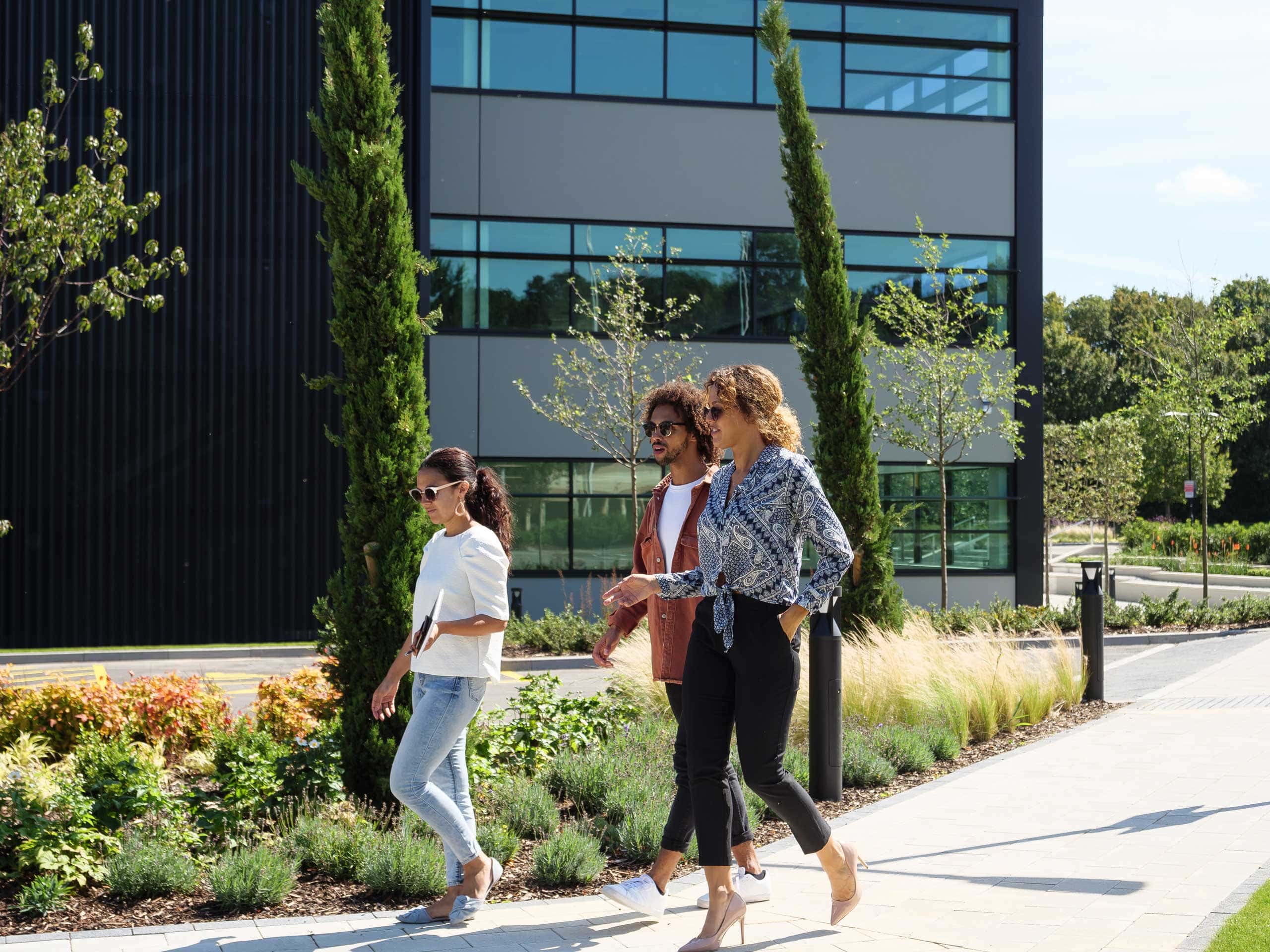 three people waking towards the office