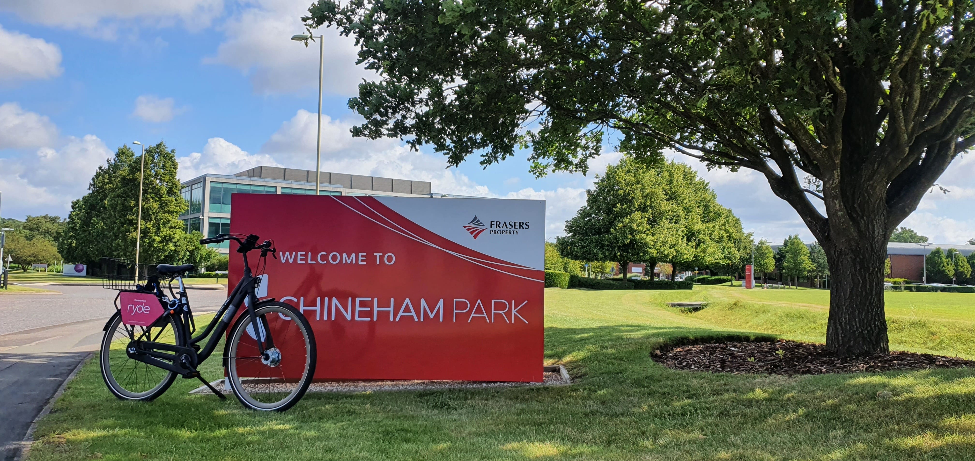 A bicycle is parked in front of a welcome sign.