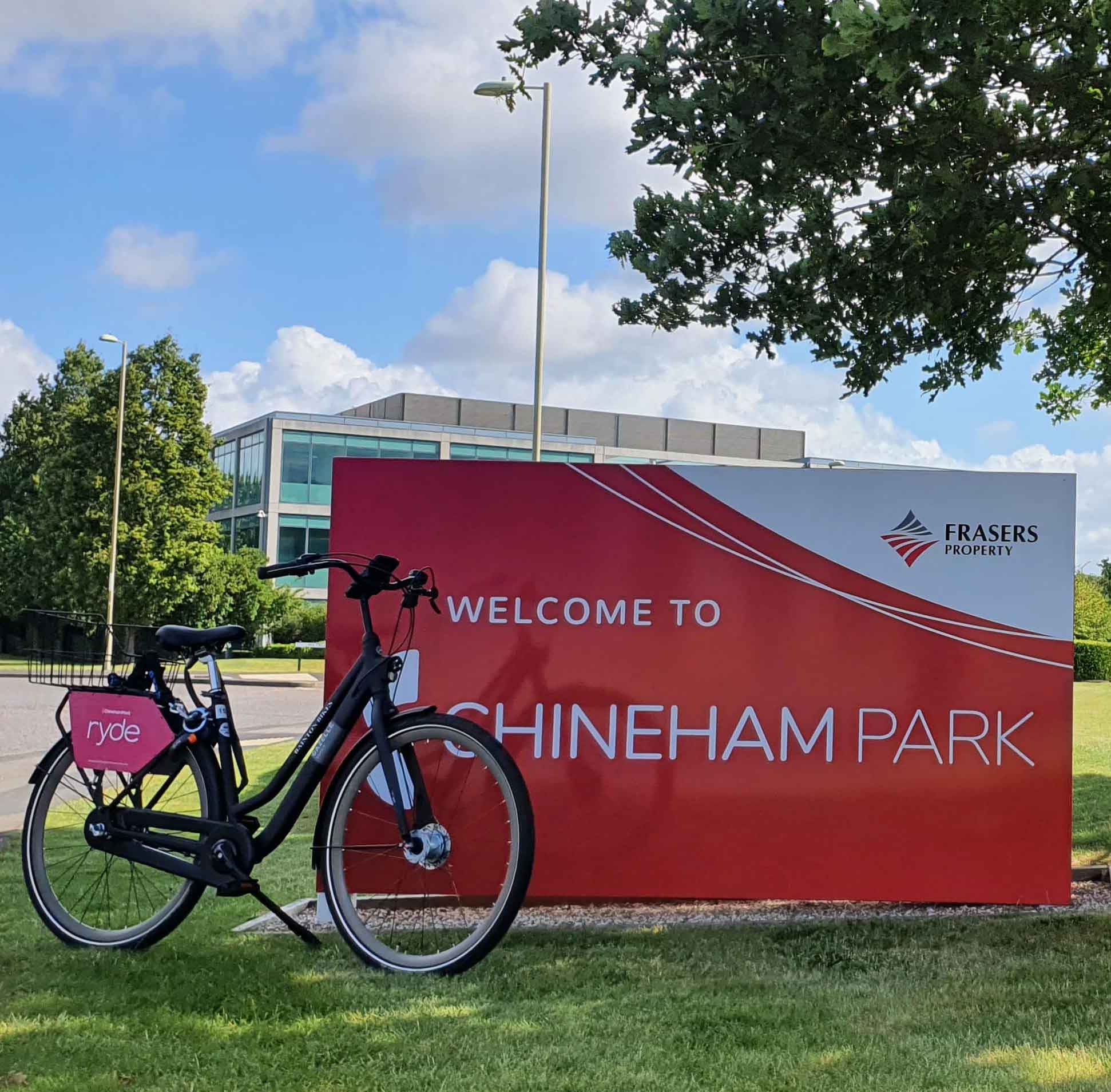 A bicycle is parked in front of a sign that says welcome to chineseham park.