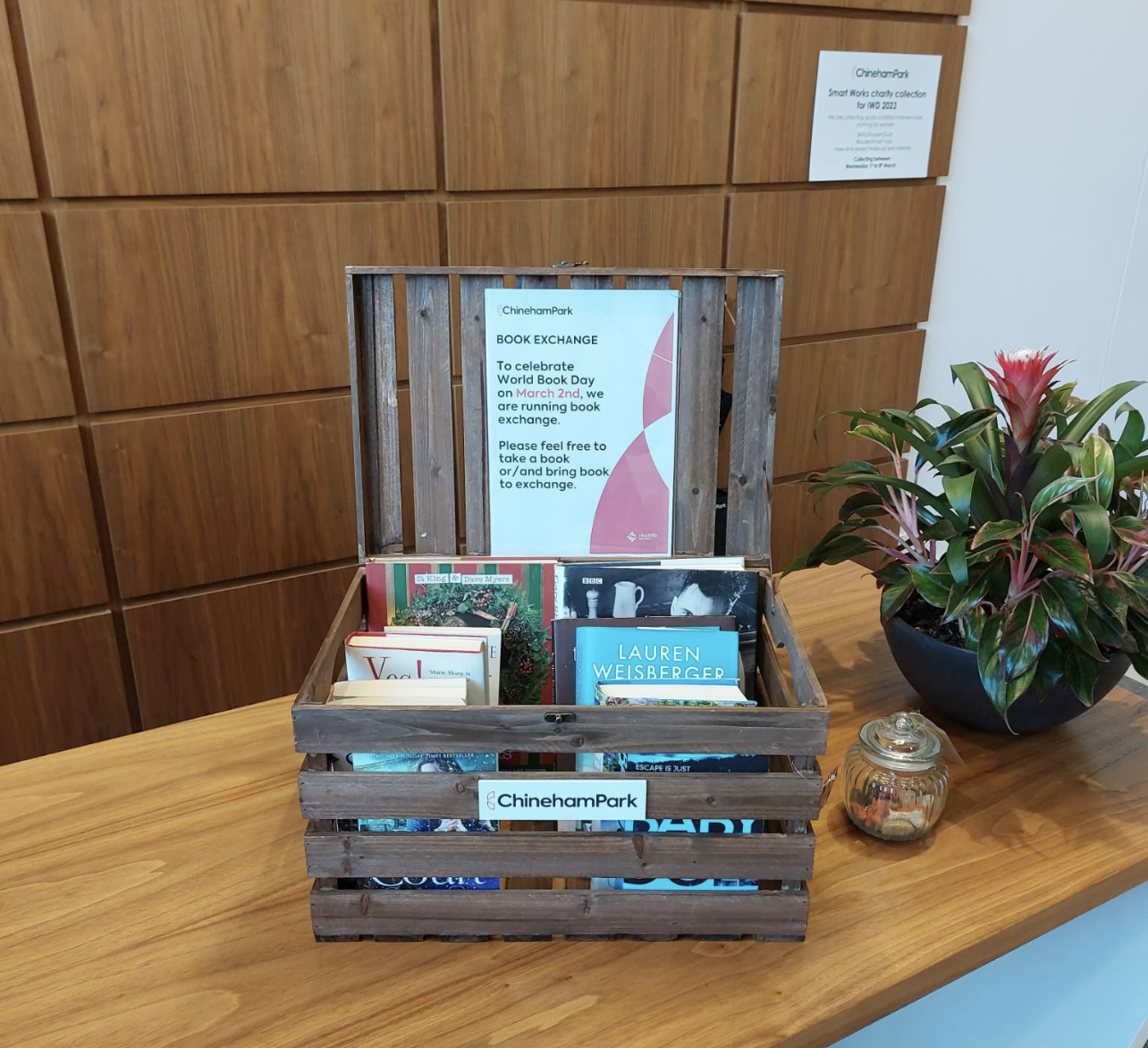 In celebration of World Book Day, a wooden crate with books sits on a table.