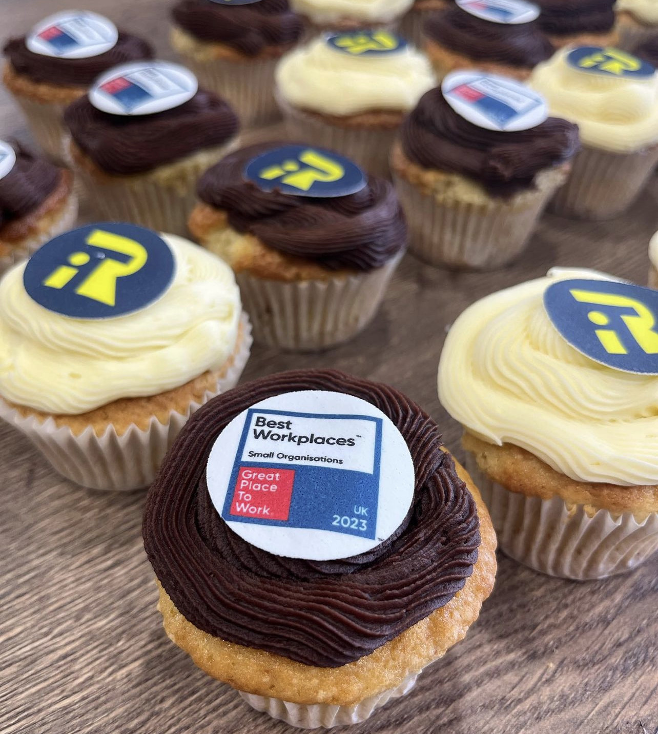 A group of cupcakes with a logo on them.