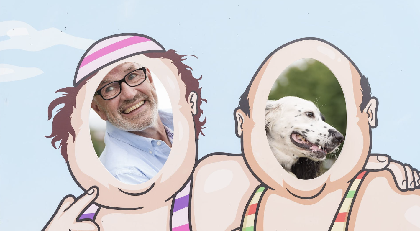 A cartoon of a man and a dog in swimsuits.